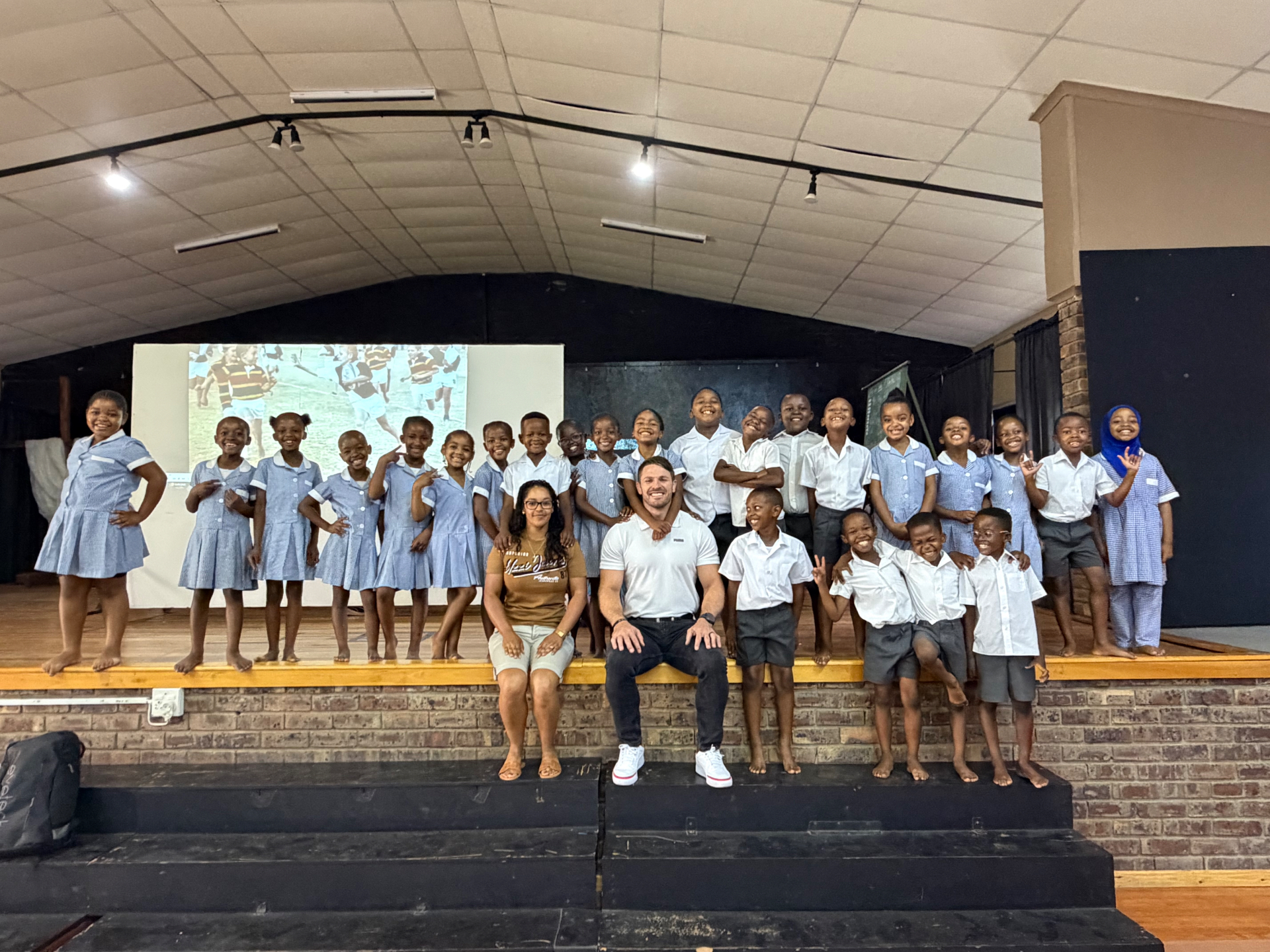 Jaco Kriel and Nastassja Ras with a school group of young learners on stage after a JK6 talk