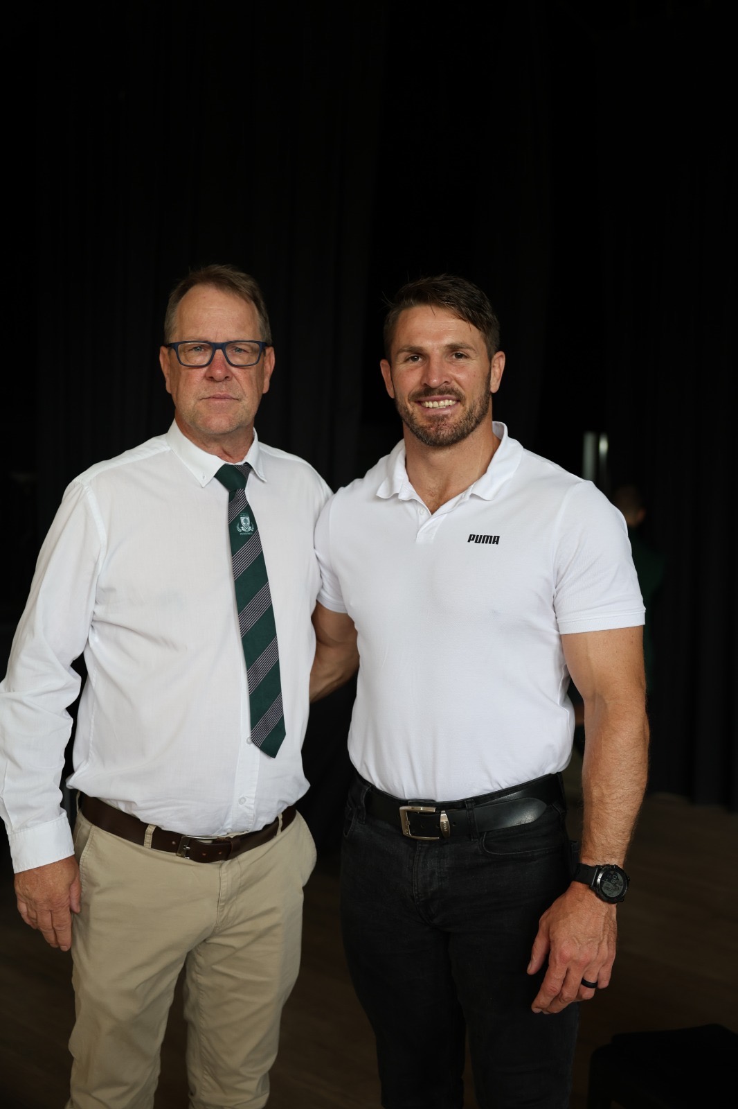 Jaco Kriel standing with a school headmaster after a JK6 talk