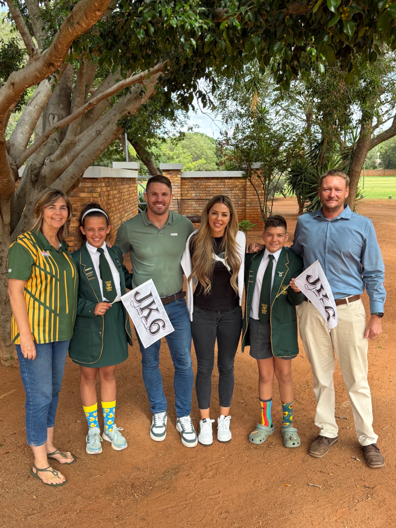 Jaco Kriel and Nastassja Ras with school prefects and staff holding JK6 flags
