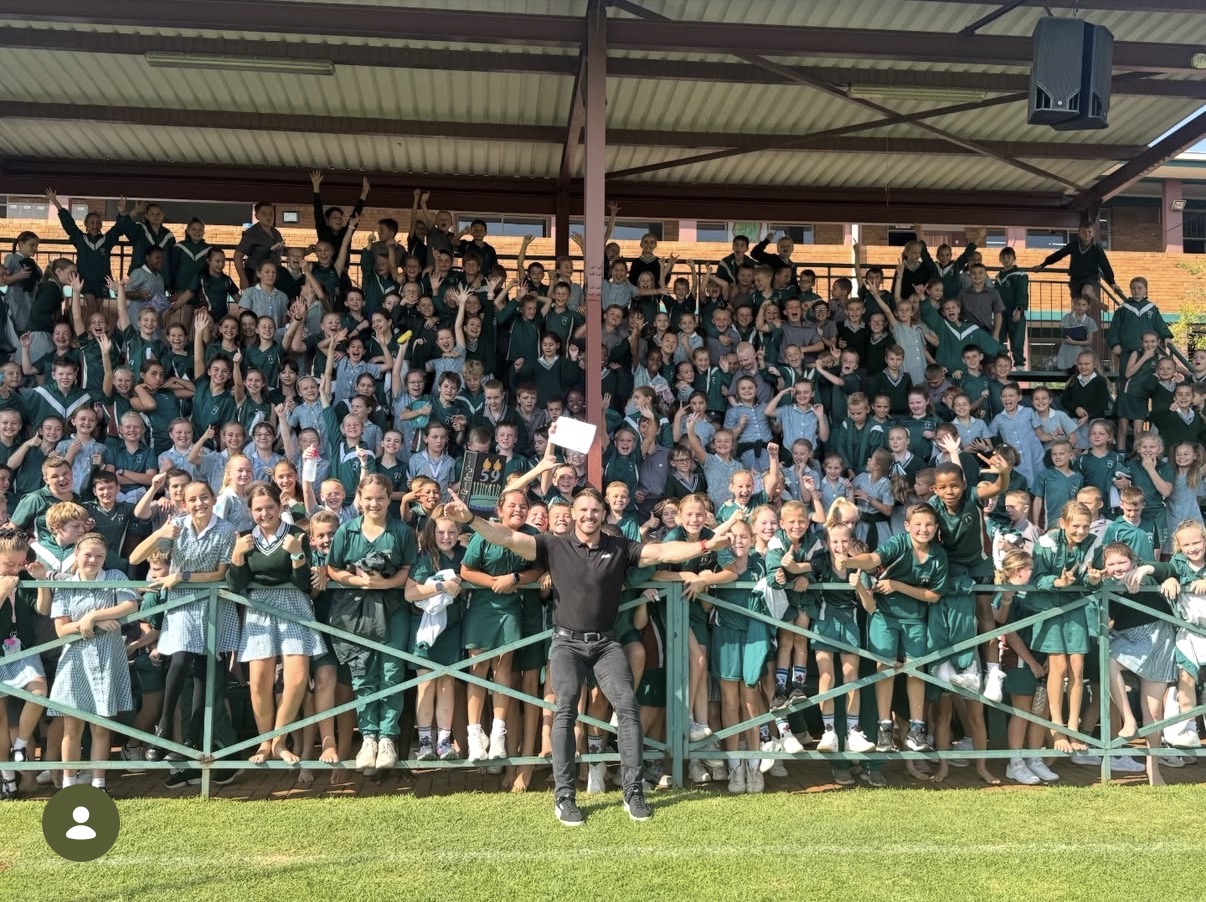 Jaco Kriel celebrating with primary school learners after a JK6 talk